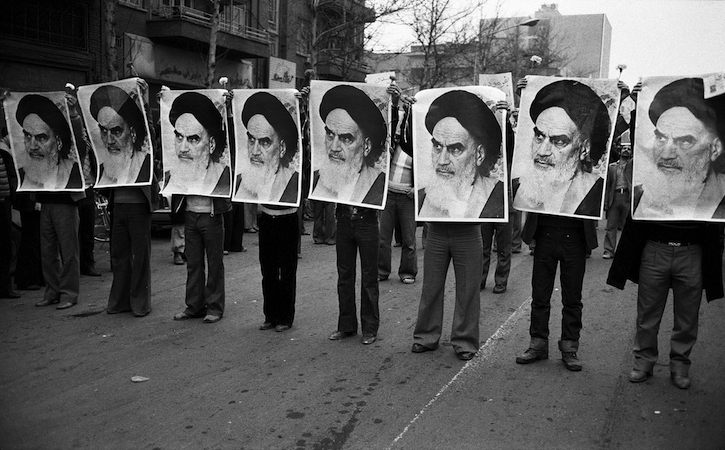 Iranian Revolution 1978 - row of men holding Khomeini photos