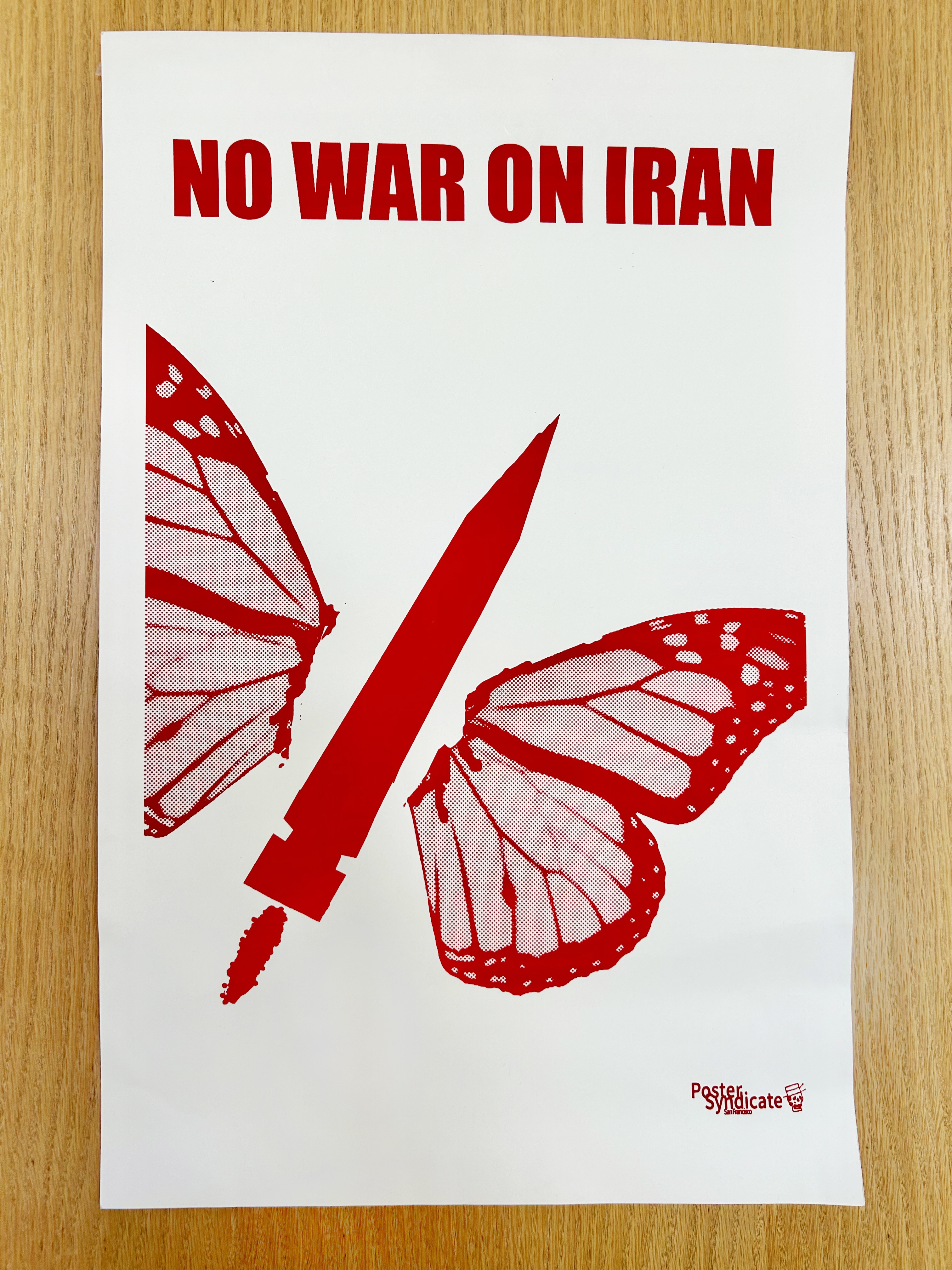 No War on Iran. Red graphic of a butterfly, the body being a missile.